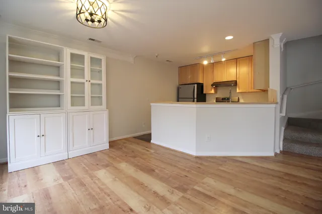a view of a kitchen with furniture and wooden floor