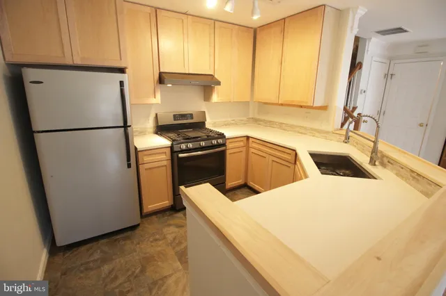 a kitchen with a refrigerator sink and stove