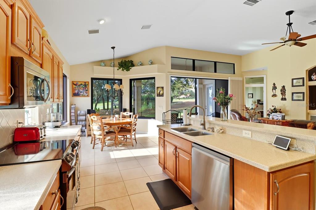 366 West Doerr Path Hernando, FL 34442 - Photo 14 of 47 a large white kitchen with a large window and stainless steel appliances