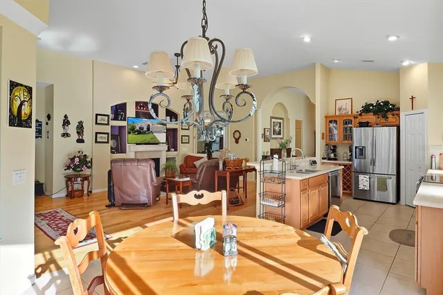 a room with gym equipment and view of kitchen