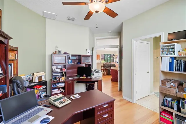 a work room with furniture and a book shelf