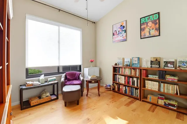 a bedroom with a bed and a large window