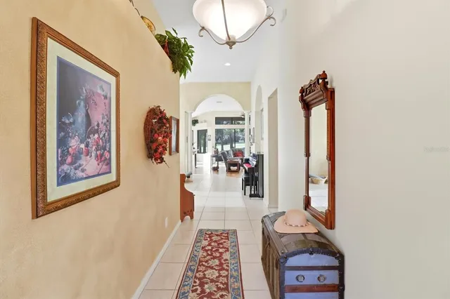 a picture of a living room with a mirror and a rug