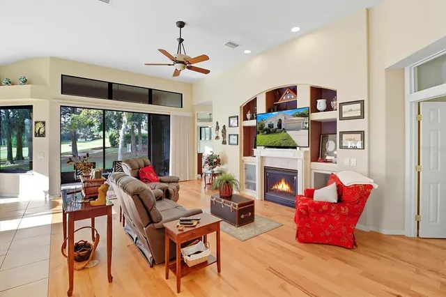 a living room with fireplace furniture and a large window