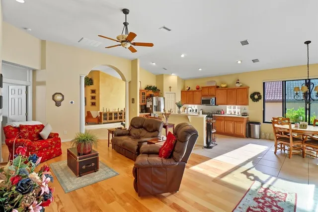 a living room with lots of furniture and a chandelier