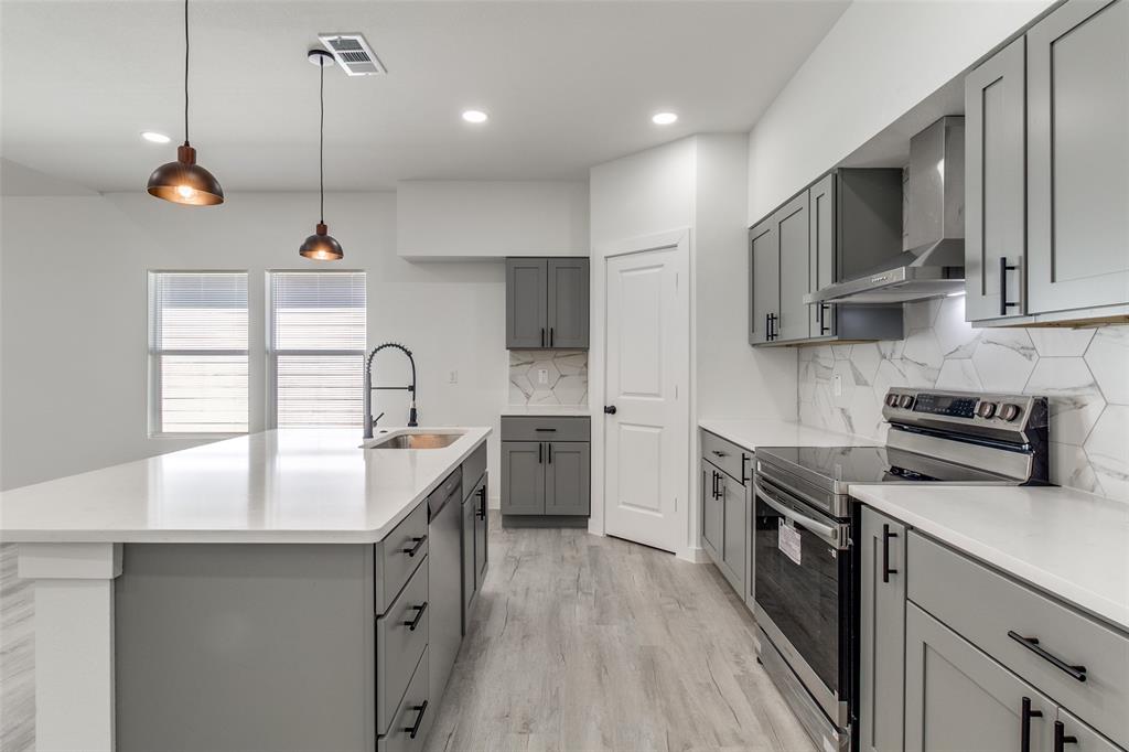 3108 Delafield Lane Dallas, TX 75227 - Photo 14 of 30 a kitchen with stainless steel appliances granite countertop a sink a stove and a wooden floors