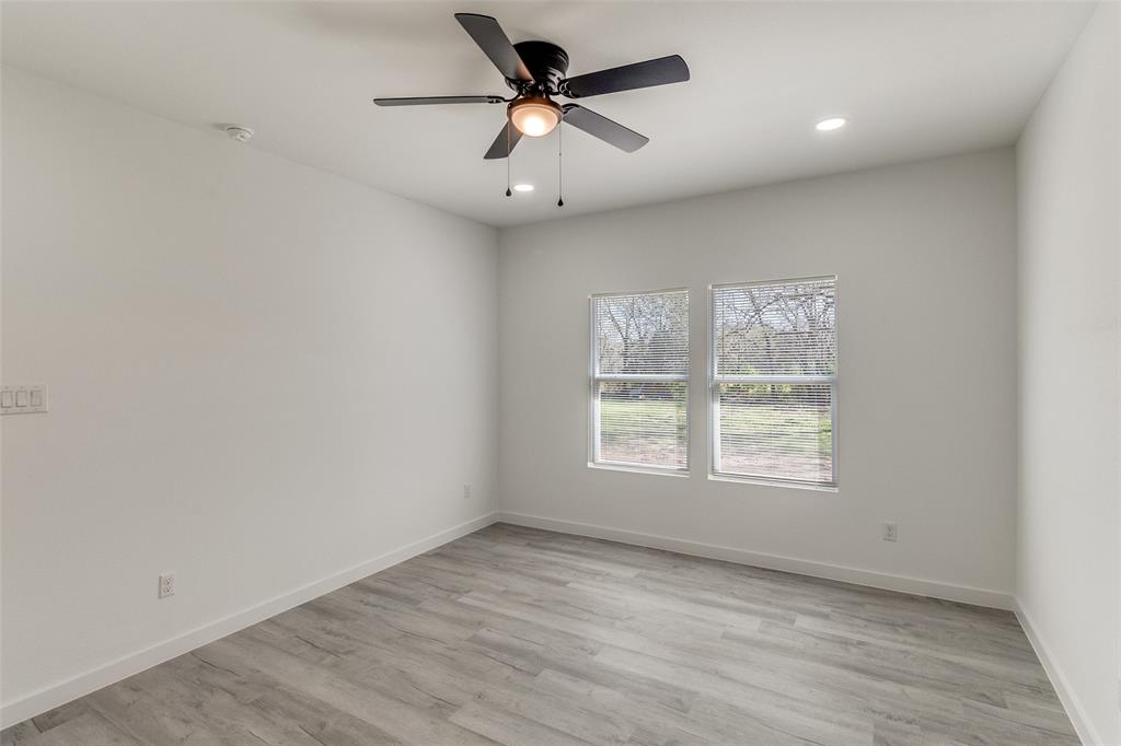 3108 Delafield Lane Dallas, TX 75227 - Photo 17 of 30 an empty room with a window and a fan
