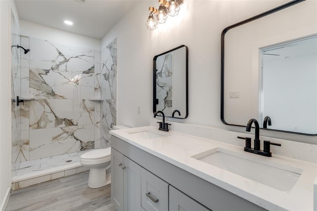 3108 Delafield Lane Dallas, TX 75227 - Photo 19 of 30 a bathroom with a double vanity sink toilet and shower