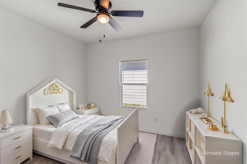 3108 Delafield Lane Dallas, TX 75227 - Photo 21 of 30 a bedroom with a bed and a window