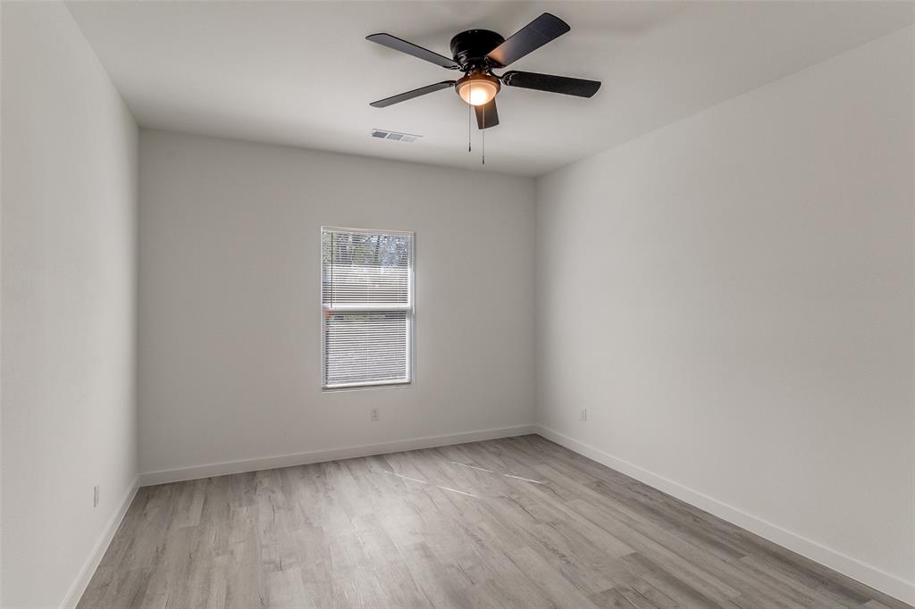 3108 Delafield Lane Dallas, TX 75227 - Photo 23 of 30 an empty room with a window and a fan
