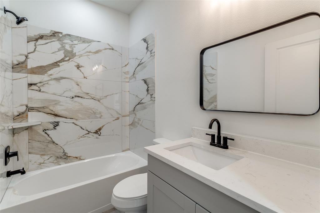 3108 Delafield Lane Dallas, TX 75227 - Photo 24 of 30 a bathroom with a sink a toilet and a bathtub