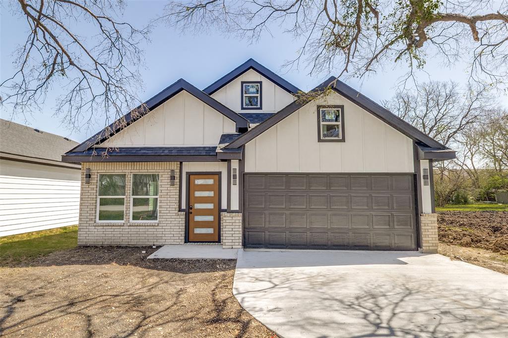 3108 Delafield Lane Dallas, TX 75227 - Photo 30 of 30 a front view of a house with a yard and garage