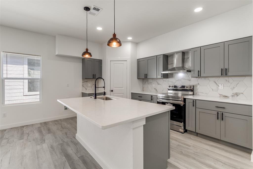 3108 Delafield Lane Dallas, TX 75227 - Photo 7 of 30 a kitchen with a sink a stove and cabinets