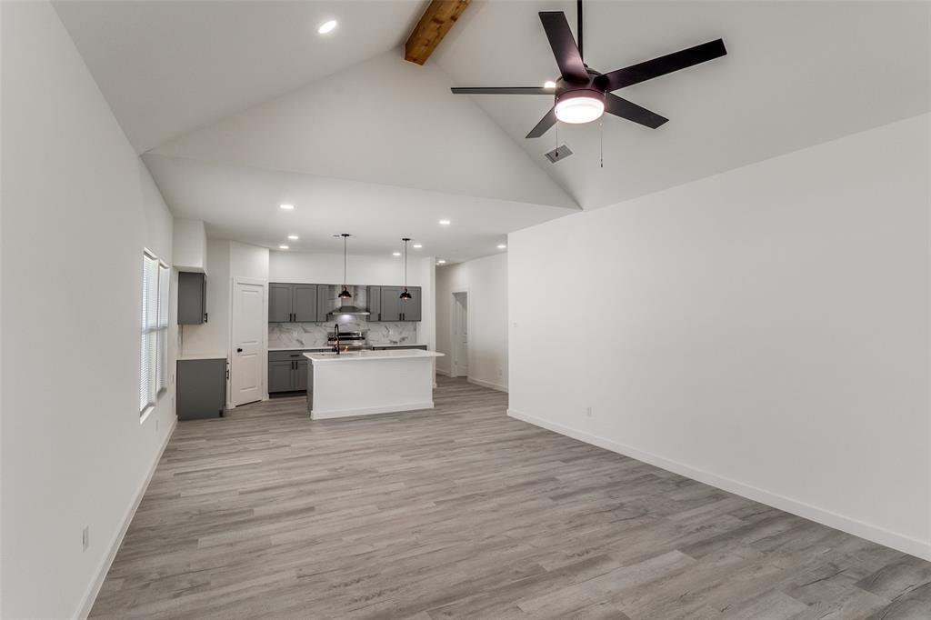 3108 Delafield Lane Dallas, TX 75227 - Photo 10 of 30 a view of kitchen with microwave a stove and white cabinets