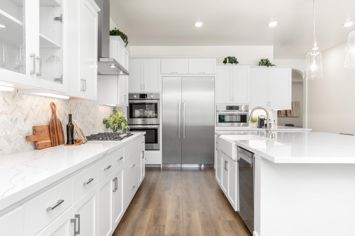 4792 Crowne Point Rocklin, CA 95677 - Photo 17 of 69 Kitchen with quartz countertops and chevron backsplash.