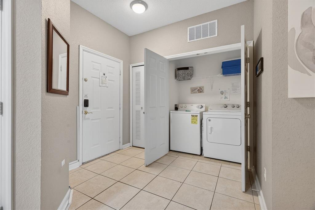 7664 Comrow Street, Unit 304 Kissimmee, FL 34747 - Photo 12 of 42 a view of a storage & utility room with sink dryer and washer