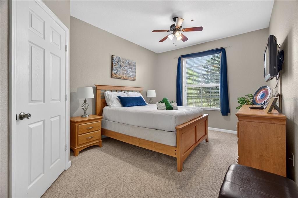 7664 Comrow Street, Unit 304 Kissimmee, FL 34747 - Photo 13 of 42 a bedroom with a bed and a chandelier