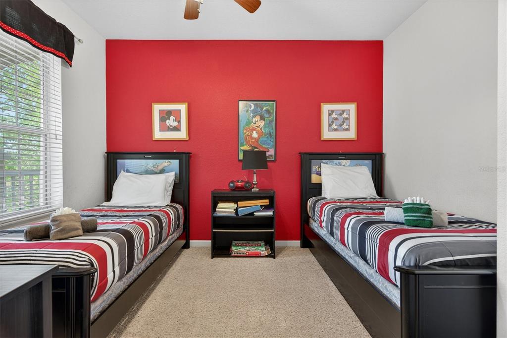 7664 Comrow Street, Unit 304 Kissimmee, FL 34747 - Photo 17 of 42 a bedroom with a bed and wooden floor