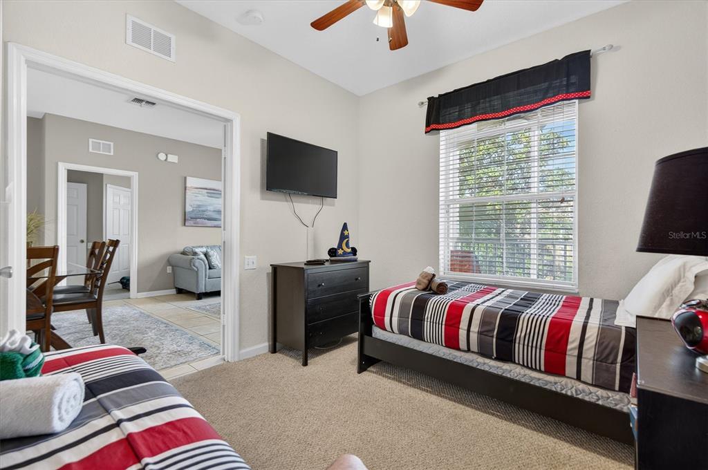 7664 Comrow Street, Unit 304 Kissimmee, FL 34747 - Photo 18 of 42 a living room with a balcony furniture and a flat screen tv