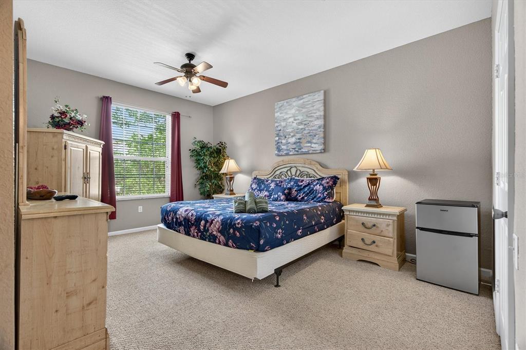 7664 Comrow Street, Unit 304 Kissimmee, FL 34747 - Photo 19 of 42 a bedroom with a bed and a chandelier