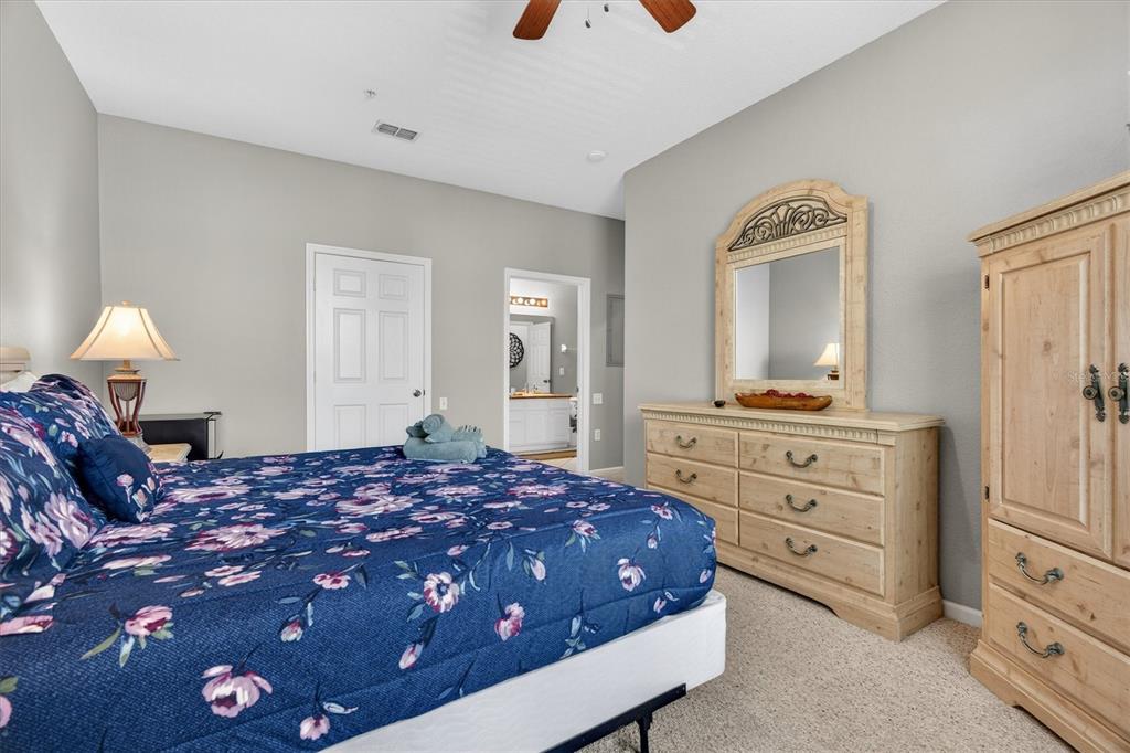 7664 Comrow Street, Unit 304 Kissimmee, FL 34747 - Photo 20 of 42 a bedroom with a bed and a dresser