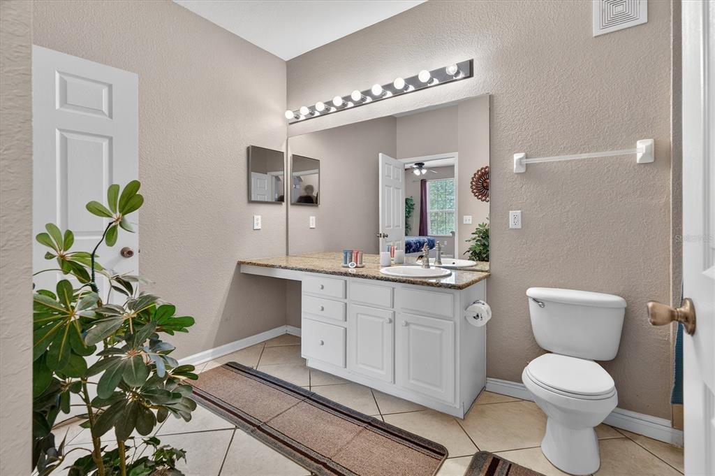 7664 Comrow Street, Unit 304 Kissimmee, FL 34747 - Photo 23 of 42 a bathroom with a toilet sink and mirror