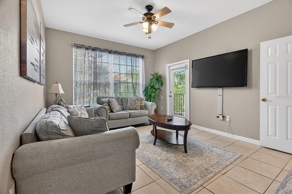 7664 Comrow Street, Unit 304 Kissimmee, FL 34747 - Photo 24 of 42 a living room with furniture and a flat screen tv