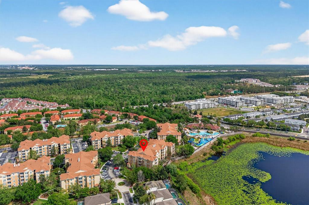 7664 Comrow Street, Unit 304 Kissimmee, FL 34747 - Photo 37 of 42 an aerial view of residential houses with outdoor space and trees
