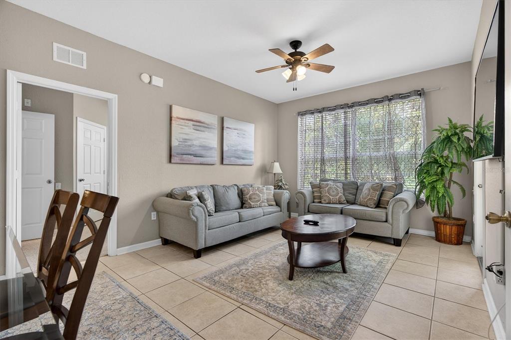 7664 Comrow Street, Unit 304 Kissimmee, FL 34747 - Photo 6 of 42 a living room with furniture and wooden floor