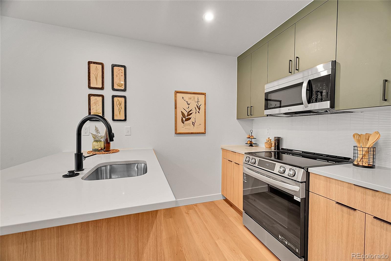 765 East County Line Road Erie, CO 80516 - Photo 9 of 28 a kitchen with granite countertop a stove and a sink
