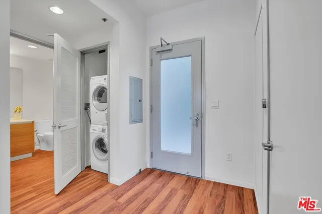a view of a storage & utility room with closet wooden floor