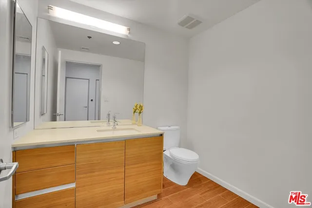 a bathroom with a sink a toilet and mirror