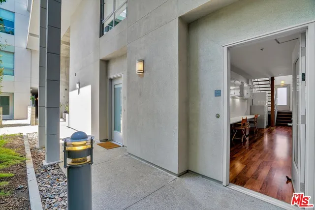 a view of a hallway with living room and furniture