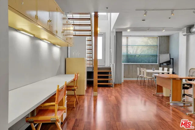 a view of a room with furniture and wooden floor