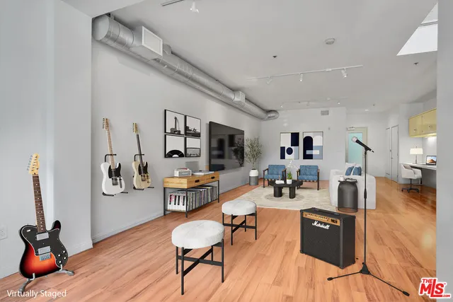 a dining room with wooden floor and large windows