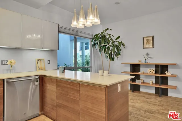 a room with kitchen island a sink and a stove