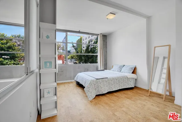 a living room with a bed furniture and a window