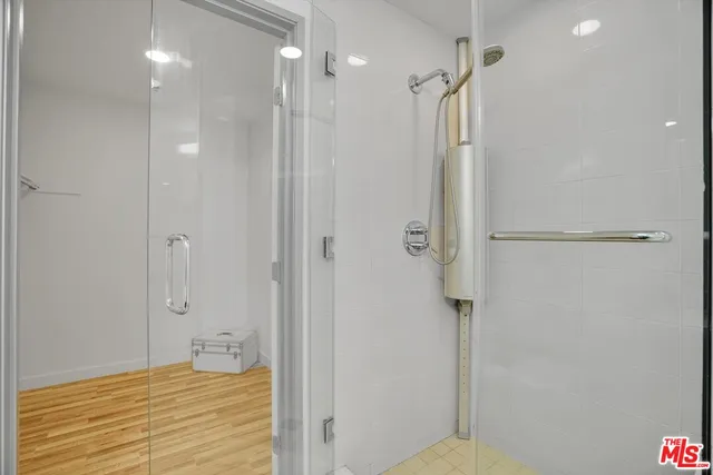 a bathroom with a shower and a glass door