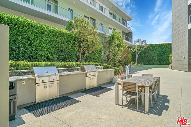 a view of a patio with table and chairs and potted plants