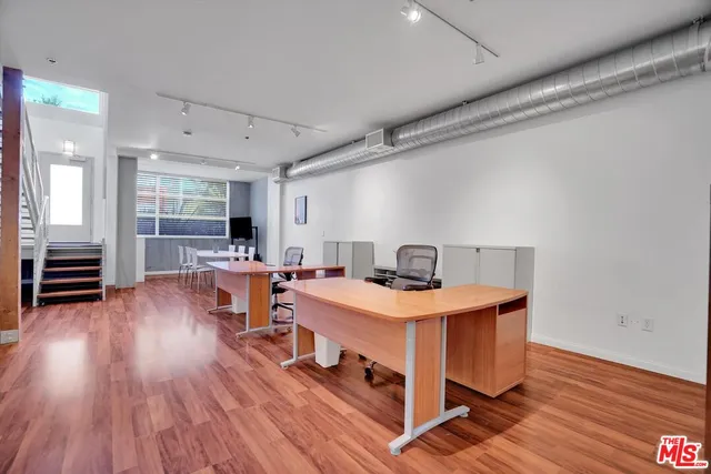 a view of a dining room with furniture wooden floor and a rug