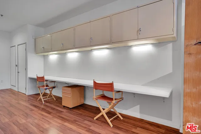 a workspace with wooden floor and a cabinet