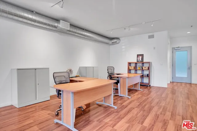 a room with a wooden table and chairs