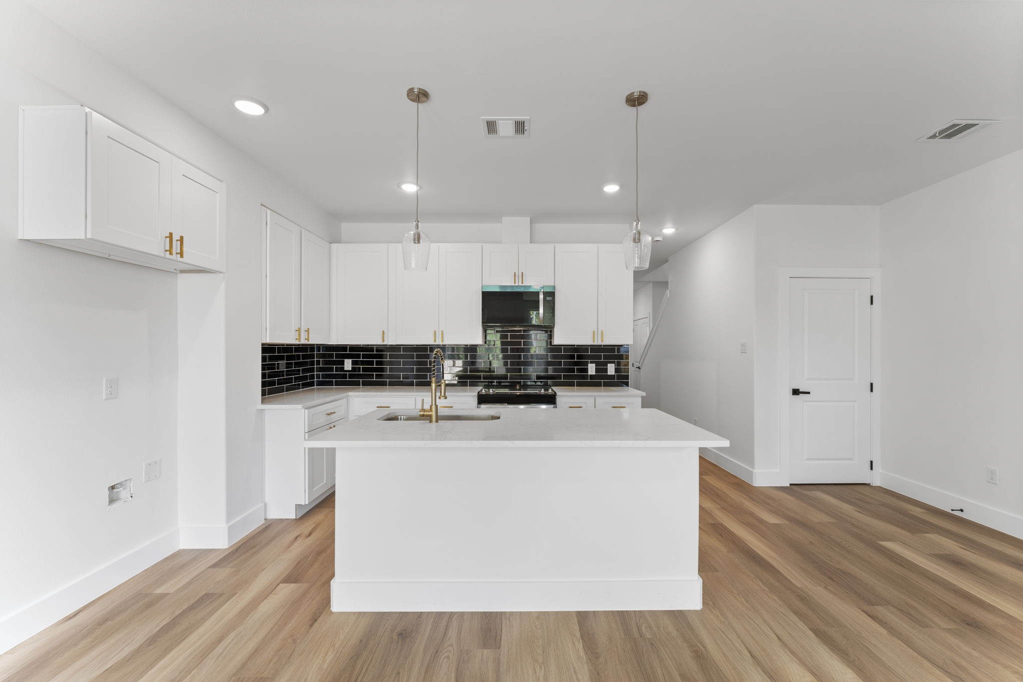 8205 Carver Road Houston, TX 77088 - Photo 11 of 37 a view of a kitchen with kitchen island a sink stainless steel appliances and cabinets