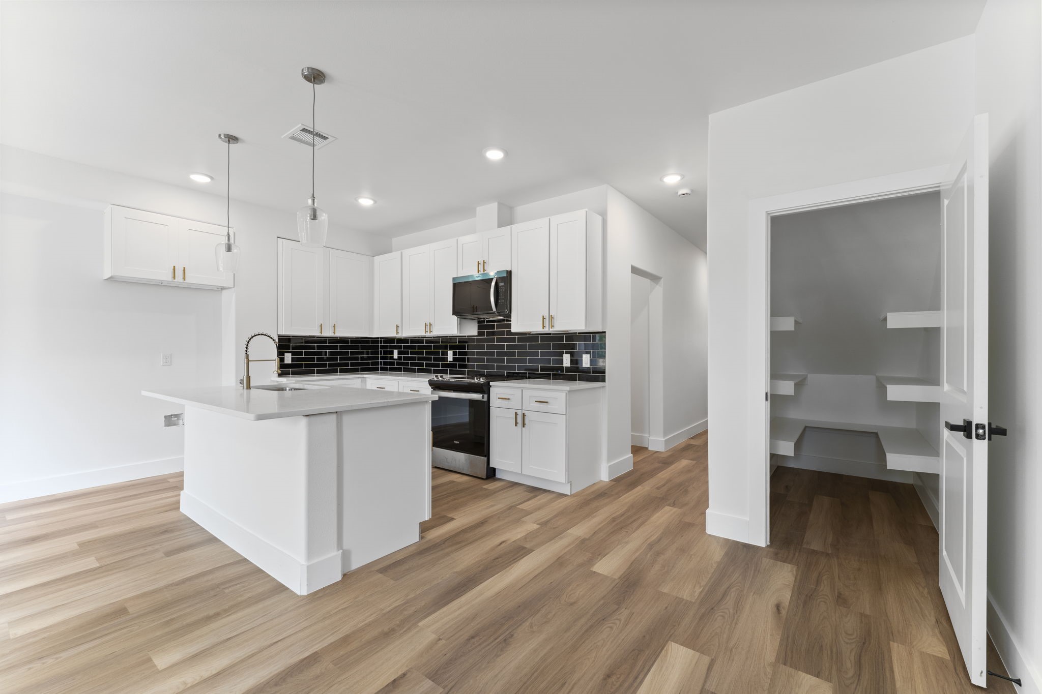 8205 Carver Road Houston, TX 77088 - Photo 12 of 37 a kitchen with a refrigerator and a stove top oven