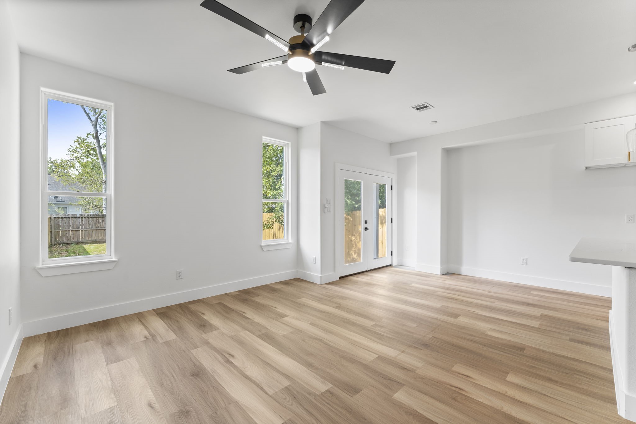 8205 Carver Road Houston, TX 77088 - Photo 13 of 37 a view of an empty room with a window and wooden floor