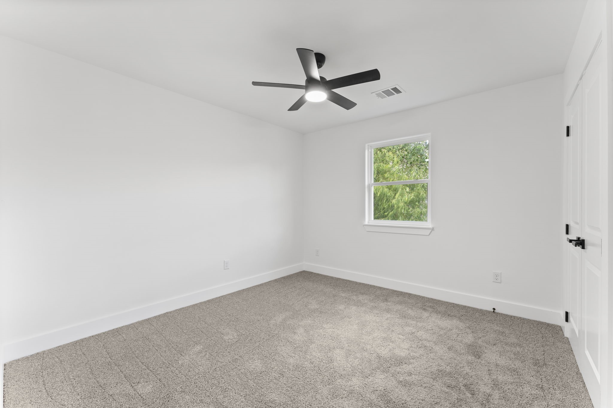 8205 Carver Road Houston, TX 77088 - Photo 20 of 37 an empty room with a window and a fan