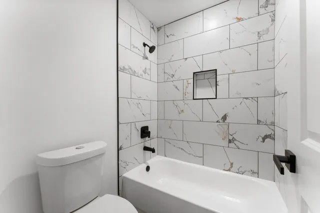 a bathroom with a bathtub and a toilet