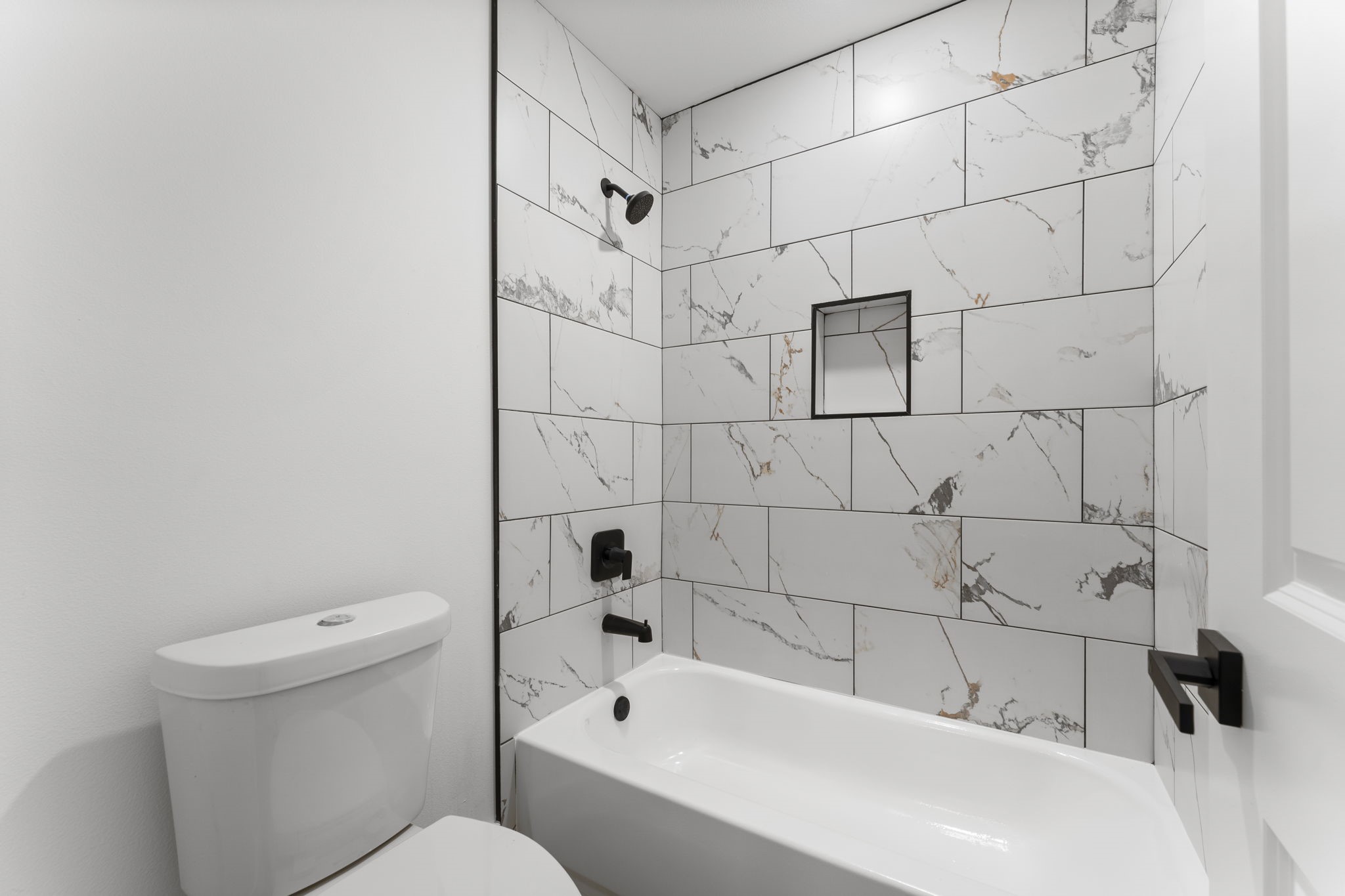 8205 Carver Road Houston, TX 77088 - Photo 23 of 37 a bathroom with a bathtub and a toilet