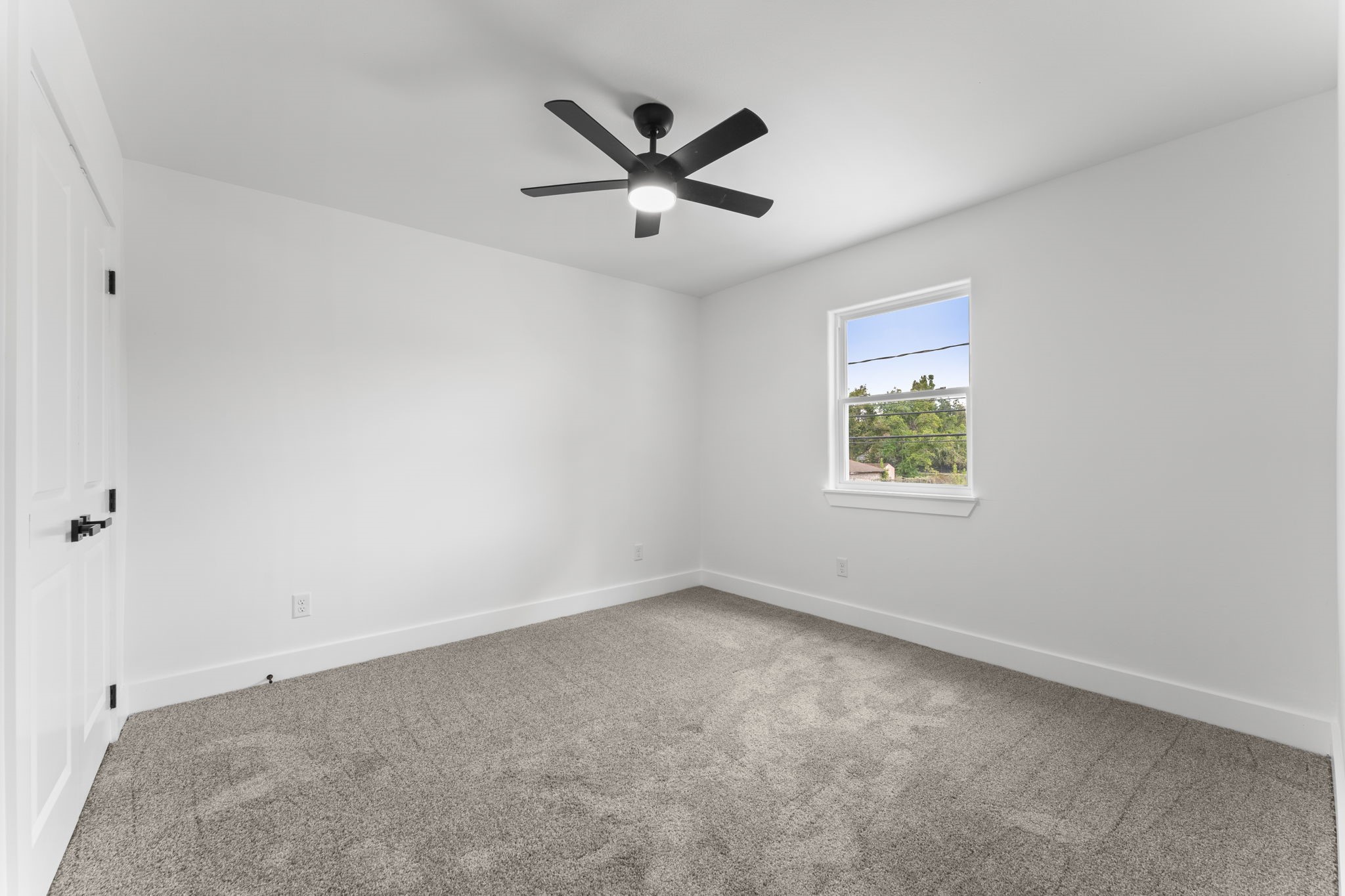 8205 Carver Road Houston, TX 77088 - Photo 24 of 37 an empty room with ceiling fan and windows