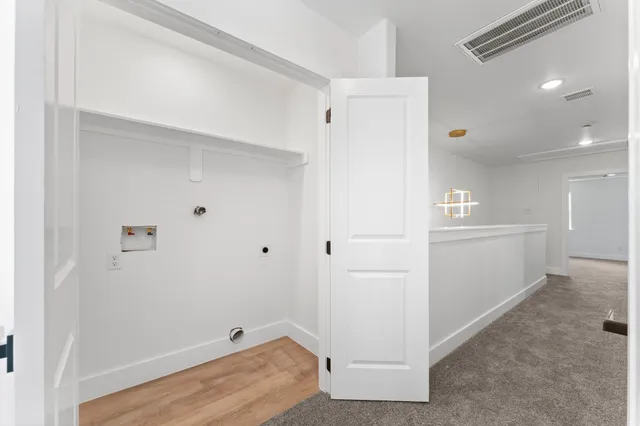 a view of room with hardwood floor and hallway